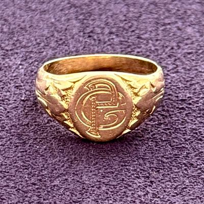 an image of a gold ring on a purple surface