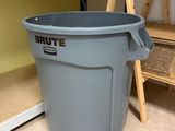 a trash can sitting in the corner of a room