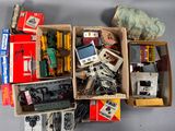 a box full of assorted toy trains and other items