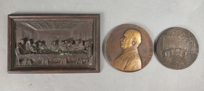 two bronze medallions of a man and a woman and a picture of a man and a woman