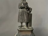 statue of a woman reading a book on a pedestal