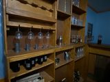 a shelf with bottles and jars on it in a room