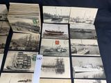 a lot of old postcards of ships on display