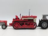 two toy tractors sitting next to each other on a white surface
