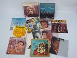 various elvis and the hollies album covers on a white surface