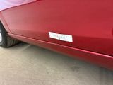 a red car with a sticker on the side of it