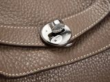 a close up of a purse with a lock on it