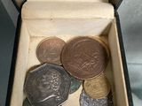 a box filled with coins sitting on a table