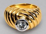 a close up of a gold ring with a diamond in the center