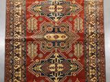 a red and blue rug with a design on it
