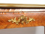 a wooden table with a gold decoration on top of it