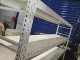 a man standing in a warehouse looking at a shelf