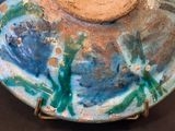 a blue and green bowl with a wooden lid