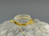 a glass vase with a gold chain around it