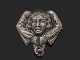 a close up of a metal object with a face on it
