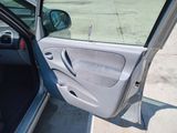a car with its door open on the side of the road