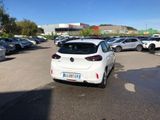 a white car parked in a parking lot next to other cars