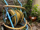 a hose that is sitting on the ground next to a wheel