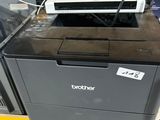 a printer sitting on top of a shelf in a store