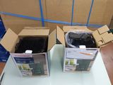 two boxes that are sitting on a table in a room