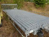 a metal bed sitting in the middle of a field