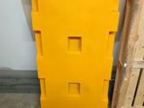 a yellow piece of plastic sitting next to a pallet