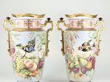 pair of vases decorated with birds and flowers on a white background