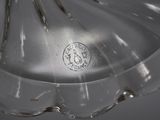 a clear glass vase with a silver handle