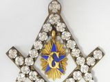 an image of a blue and gold masonic square and compass pendant