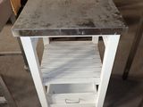 une table sur laquelle se trouve une étagère, au milieu d'une pièce