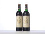 two bottles of wine sit side by side on a table
