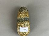 a rock with a label on it sitting on a table