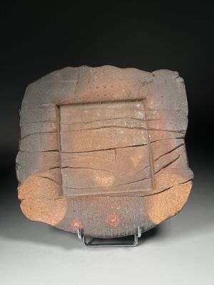 a stone plate that is sitting on a stand