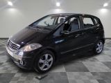 a picture of a small black car parked in a garage