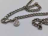 a close up of a silver chain with a coin attached to it