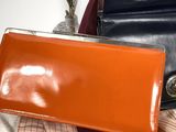 two purses sitting on top of each other on a table