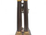 a black and gold clock with a bell on top of it