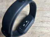 a close up of a black wristband on a wooden surface