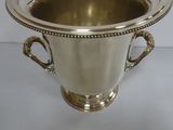 a silver vase that is sitting on a table