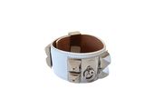 white leather bracelet with silver metal studs on a white background