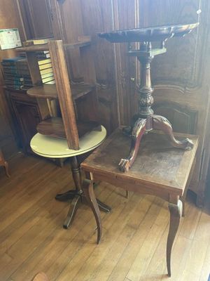 a small table with a bird on top of it in a room