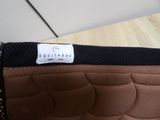a brown and black bag with a label on it