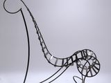sculpture of a chaise with curved legs and a curved seat