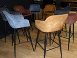 many different colored chairs in a room with wood flooring