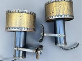 pair of brass and silver wall lights with stars on them