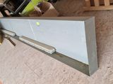 an image of a piece of metal in a warehouse
