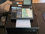 a cash register and a calculator sitting on a table