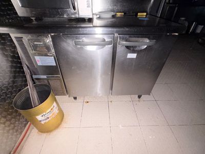 une photo d'une cuisine professionnelle avec une poubelle posée au milieu du sol