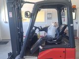 a red fork truck parked in a garage