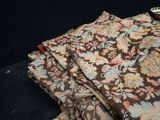 a pile of fabric on a table with a bowl on it